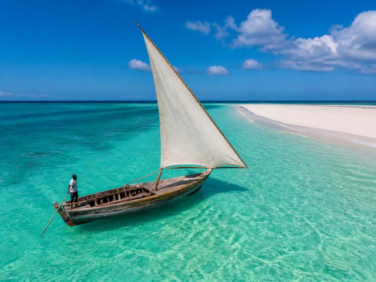 Wooden dhow sailing off Zanzibar at golden hour