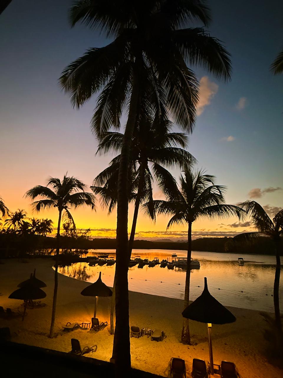 Sunset over a palm-fringed lagoon in Mauritius